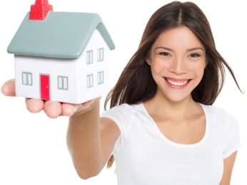 Happy homebuyer in front of a new home